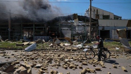 A local resident walks past an industrial building damaged by a Russian military strike, as Russia's ...