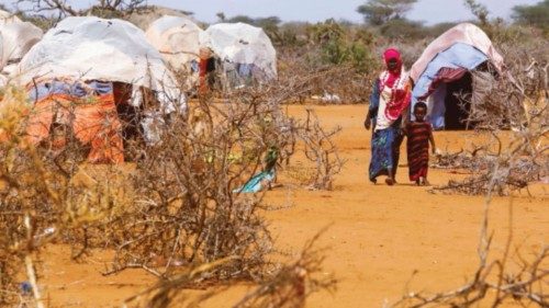 Civilians walk at the Kaxareey  camp for the internally displaced people in Dollow, Gedo region of ...