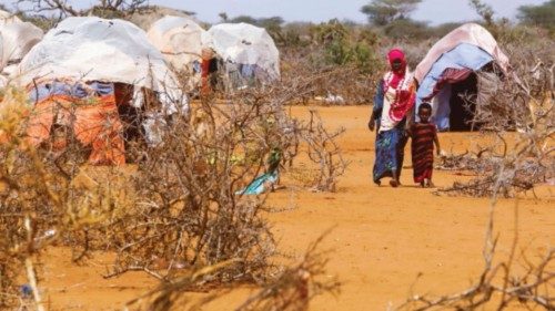 Civilians walk at the Kaxareey camp for the internally displaced people in Dollow, Gedo region of ... Civilians walk at the Kaxareey camp for the internally displaced people in Dollow, Gedo region of ...