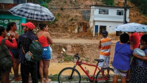 Residents look at a landslide area at the community Jardim Monte Verde, Ibura neighbourhood, in ...