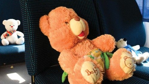 Stuffed toys symbolizing each of 243 killed Ukrainian children sit on seats in an empty yellow ... Stuffed toys symbolizing each of 243 killed Ukrainian children sit on seats in an empty yellow ...
