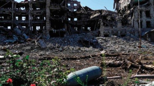 A non exploded aviation bomb FAB-250 is pictured in front of a destroyed building in the city of ...