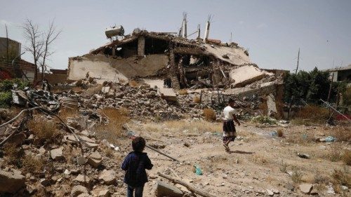 epaselect epa09992005 Yemenis pass the rubble of a building destroyed by previous Saudi-led ...
