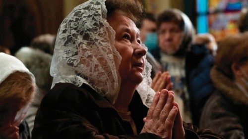 A woman prays during a Divine Liturgy at St. George Ukrainian Catholic Church in New York City Feb. ...