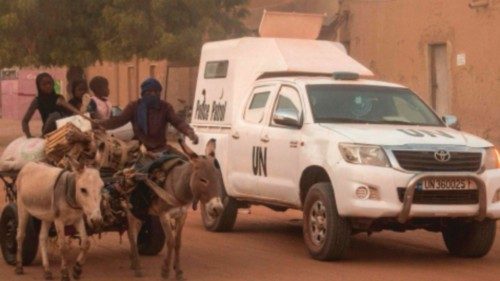 (FILES) In this file photo taken on December 09, 2021 a donkey carriage passes an armoured vehicle ...