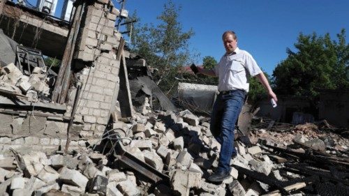 A man walks among rubbles of a house following a last night military strike, amid Russia's attack on ...