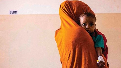 TOPSHOT - A mother holds her malnourished baby in Banadir Maternity and Children Hospital in ...