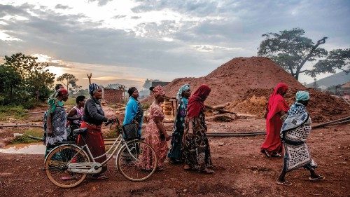 Tanzanian miners belonging to an only-women miners association walk together at sunset after their ...