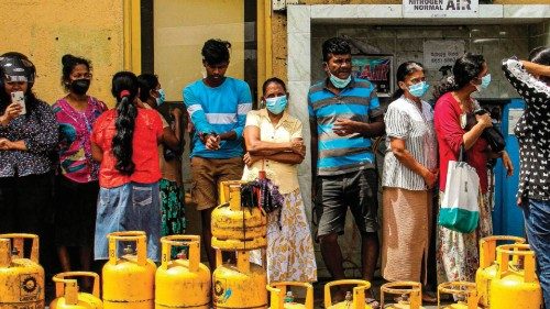 People queue up to buy Liquefied Petroleum Gas (LPG) cylinders in Colombo on June 5, 2022. (Photo by ...