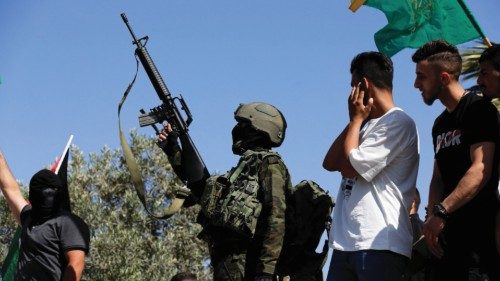 A Palestinian militant fires his weapon during the funeral of Palestinian Mahmoud Abu Ayhour, who ...