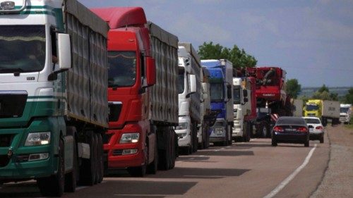 Trucks with grain wait for crossing the Ukraine-Moldova border in Odesa region, as Russia's attack ...