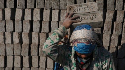 epa09664167 Migrant workers at a brick factory in Pharping, on the outskirts of Kathmandu, Nepal, 03 ...