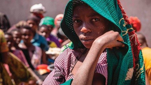 TOPSHOT - A refugee from the Democratic Republic of Congo (DRC) watis to receive lunch at the ...