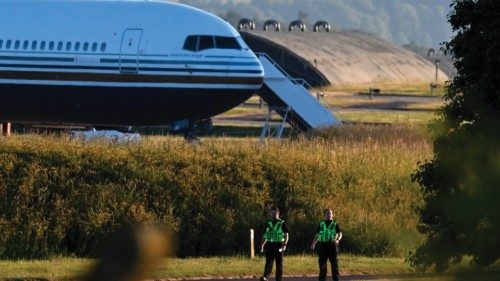 Two police officers walk in grounds near to where a Boeing 767 sits on the runway at the military ...