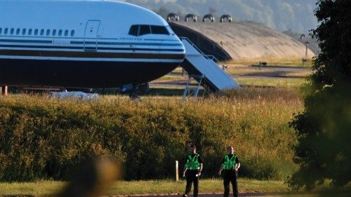 Two police officers walk in grounds near to where a Boeing 767 sits on the runway at the military ... Two police officers walk in grounds near to where a Boeing 767 sits on the runway at the military ...