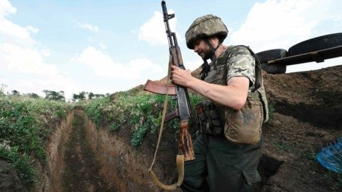 A Ukrainian serviceman Petro, 32, walks in a trench on a position held by the Ukrainian army between ...