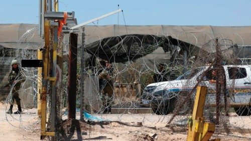 Israeli security forces stand guard at a crossing, near the site where a Palestinian worker was shot ...