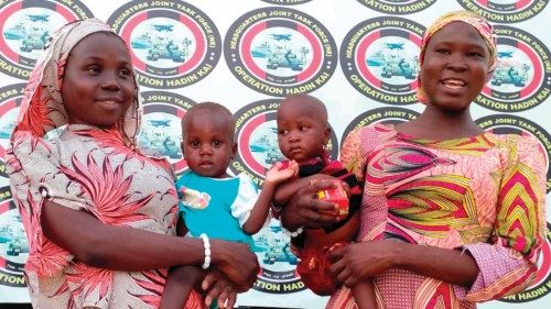 Kidnapped Chibok schoolgirls Hauwa Joseph (L) and Mary Dauda pose with their babies at Maimalari ...