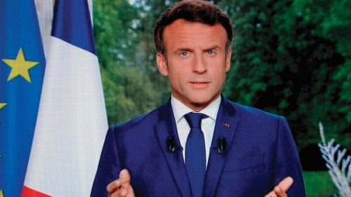 A photo of a TV screen shows French President Emmanuel Macron speaking during televised address on ...