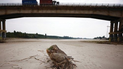 A tree trunk lies on Po's dry riverbed as parts of Italy's longest river and largest reservoir of ...