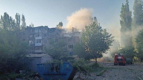 Smoke rises over a residential building hit by a Russian military strike, as Russia's attack on ...
