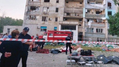 Bodies of civilian people killed by a Russian missile strike are seen in front of a damaged ... Bodies of civilian people killed by a Russian missile strike are seen in front of a damaged ...