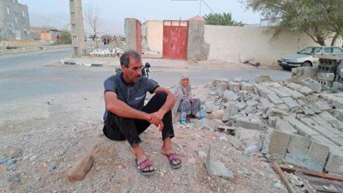 People sit by the rubble amidst destruction in the aftermath of a 6.0 magnitude earthquake in the ... People sit by the rubble amidst destruction in the aftermath of a 6.0 magnitude earthquake in the ...