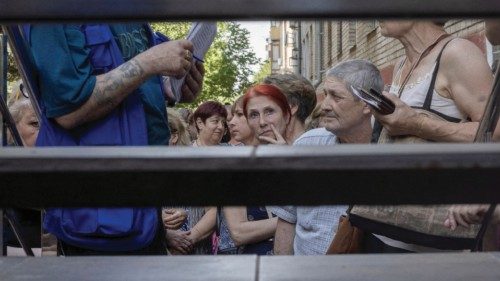 People wait to receive humanitarian aid as Russia's attack on Ukraine continues in Kramatorsk, ...