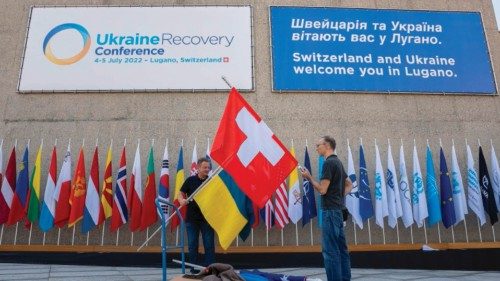 Daniel May, staff member of the Swiss Confederation (L), and a collegue, prepare the flags of ...