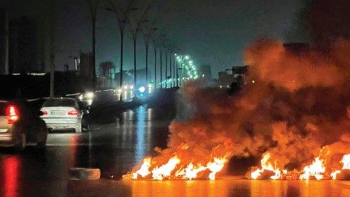 A picture taken on June 3, 2022, shows burning tyres blocking roads during overnight protests in the ...