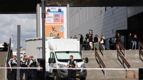 Police forces and media stand near the site of a deadly shooting on July 4, 2022, one day after it ...