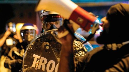 Troopers in riot gear watch as demonstrators gather outside Akron City Hall to protest the killing ...