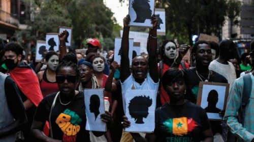 TOPSHOT - Protestors hold signs depicting silhouettes as they take part in a anti-racism ... TOPSHOT - Protestors hold signs depicting silhouettes as they take part in a anti-racism ...