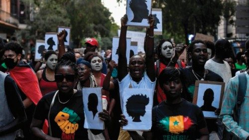 TOPSHOT - Protestors hold signs depicting silhouettes as they take part in a anti-racism ...