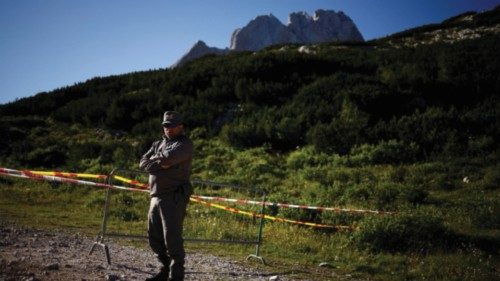 A ranger blocks a road to Marmolada ridge after deadly collapse of parts of a mountain glacier in ...