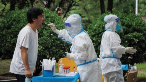 A medical worker takes a swab sample at a nucleic acid testing station, following a coronavirus ...