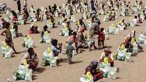 Yemenis displaced by the conflict, receive food aid and supplies to meet their basic needs, at a ...
