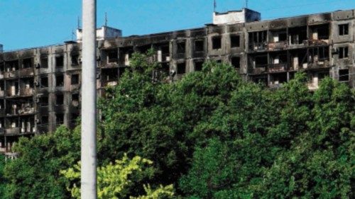 A burned car is pictured in front of a destroyed building in the city of Mariupol on July 1, 2022, ... A burned car is pictured in front of a destroyed building in the city of Mariupol on July 1, 2022, ...