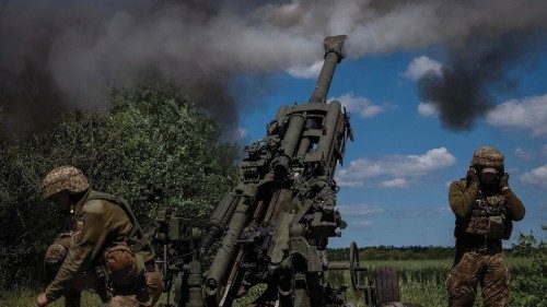 Ukrainian service members fire a shell from a M777 Howitzer near a frontline, as Russia's attack on ...