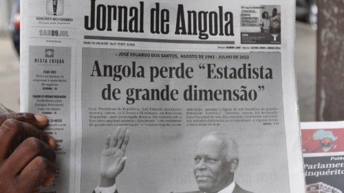 A man holds a copy of the Jornal de Angola newspaper with a headline about the death of former ...