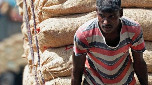 A worker pulls a cart loaded with goods at a commercial center in Colombo on July 12, 2022. (Photo ...