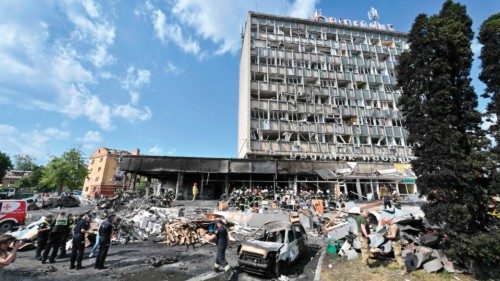Firefighters remove rubbles out of a damaged building following a Russian airstrike in the city of ...