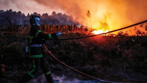 Firefighters try to control a forest fire in Louchats, south-western France, on July 17, 2022. ...