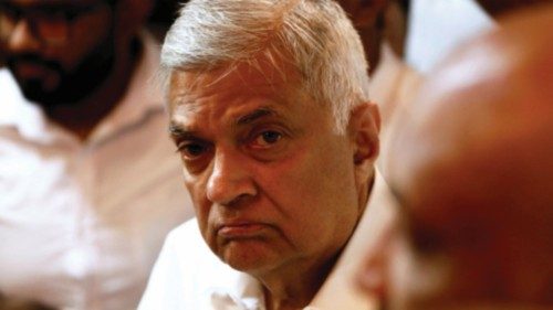 FILE PHOTO: Ranil Wickremesinghe, newly appointed prime minister, arrives at a Buddhist temple after ...