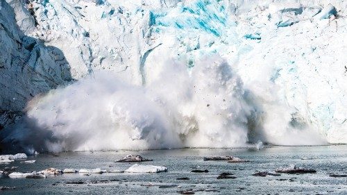 A picture taken on August 17, 2019 shows an iceberg calving with a mass of ice breaking away from ...