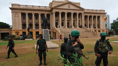 Security personnel stand guard outside the Sri Lankan Presidential Secretariat building in Colombo ...