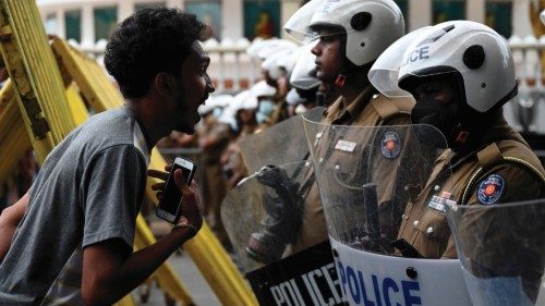 A demonstrators interacts with Police special task force personnel (R) standing guard while blocking ...