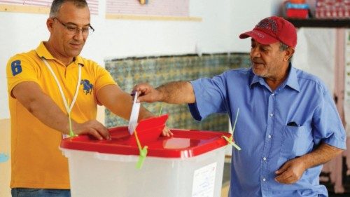 A man casts his ballot at a polling station during a referendum on a new constitution in Tunis, ...