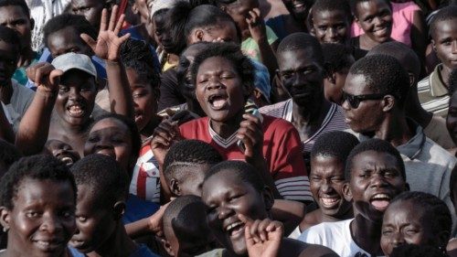 Supporters of local elective seats aspirant queue for cash handouts at a political rally in Kisumu, ...