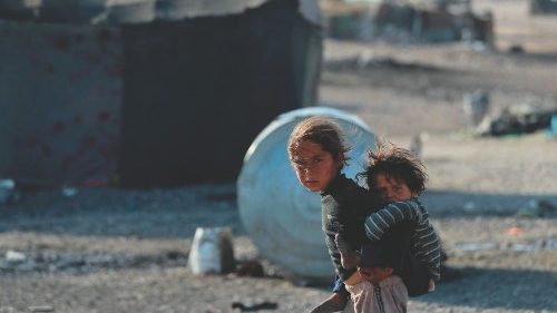 A girl carries a baby at a camp for Syrians displaced by conflict near the Syrian northern city of ...